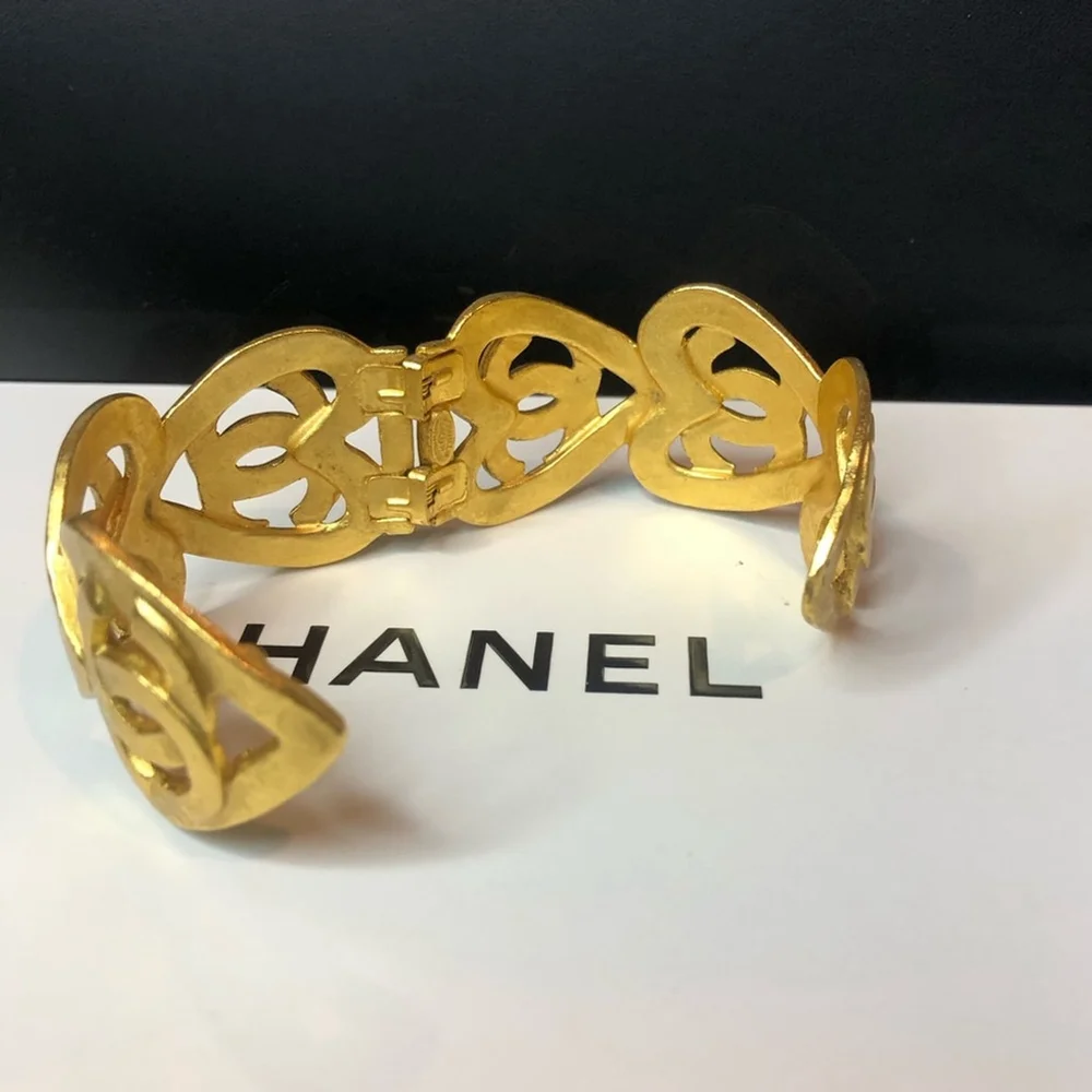 CHANEL Gold Cuff Bracelet with Interlocking CC Open Heart Design